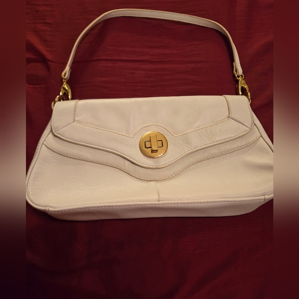 Very cute, small cream purse with a short handle. Never used. Great, clean shape